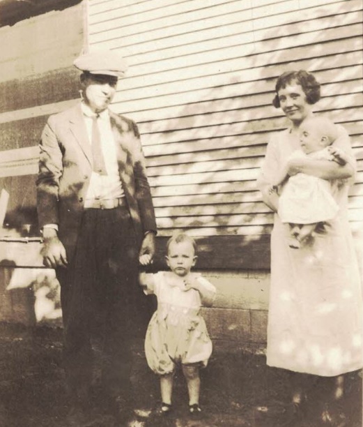 A vintage photo of a group of people posing for the camera Description automatically generated